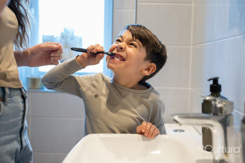 Mother and son brushing teeth together
