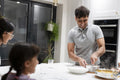 Family at table preparing meal together