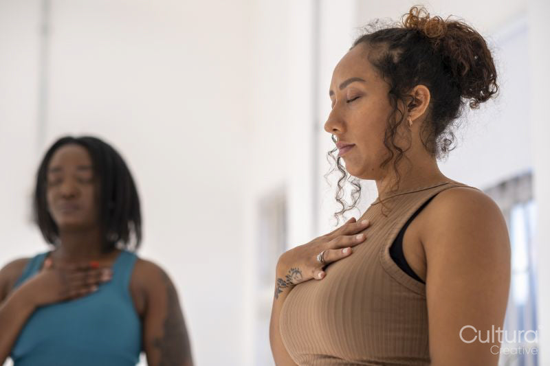 Women practicing pranayama in yoga studio