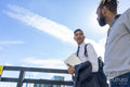 Two businessmen walking in business district