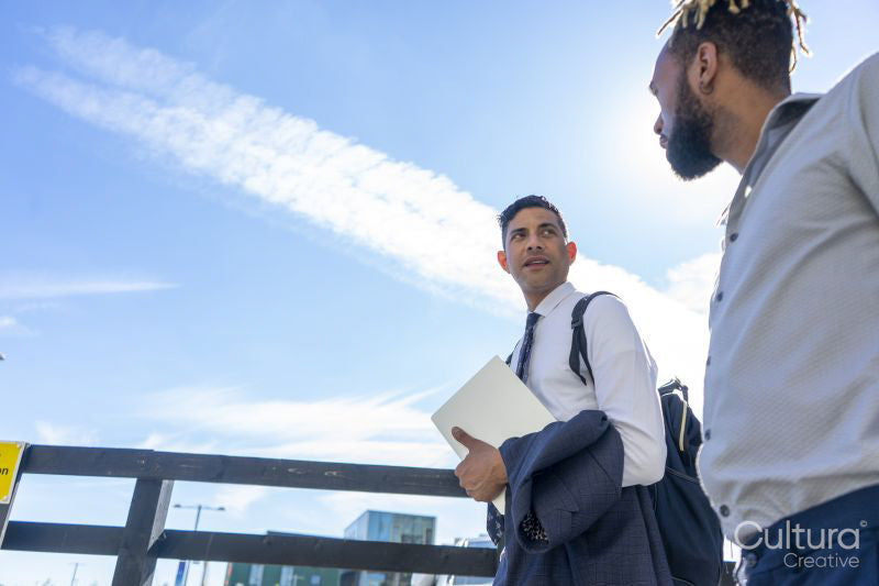 Two businessmen walking in business district