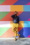 Portrait of businessman standing against colorful wall