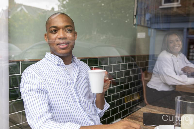 Man enjoying coffee at cafe table