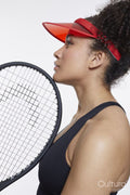 Profile of woman with tennis rocket and red sunvisor