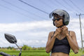 Female tourist wearing motorcycle helmet