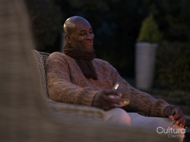 Man sitting on patio at night