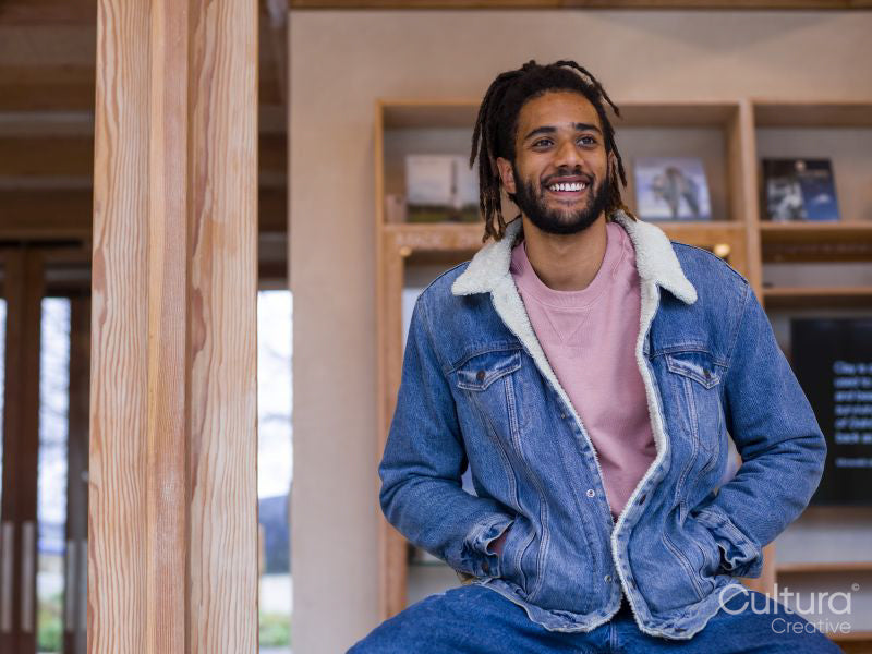 Portrait of young man sitting in lobby