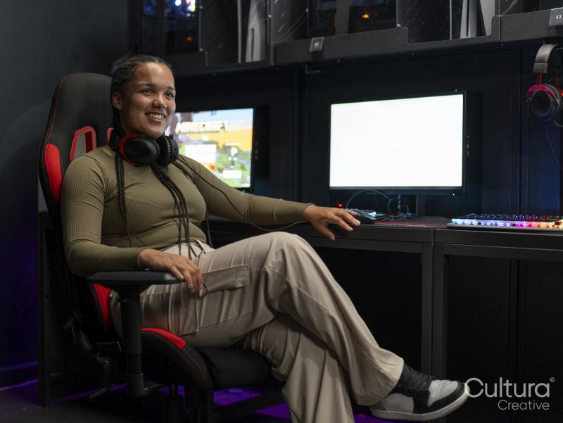 Portrait of young gamer sitting on chair