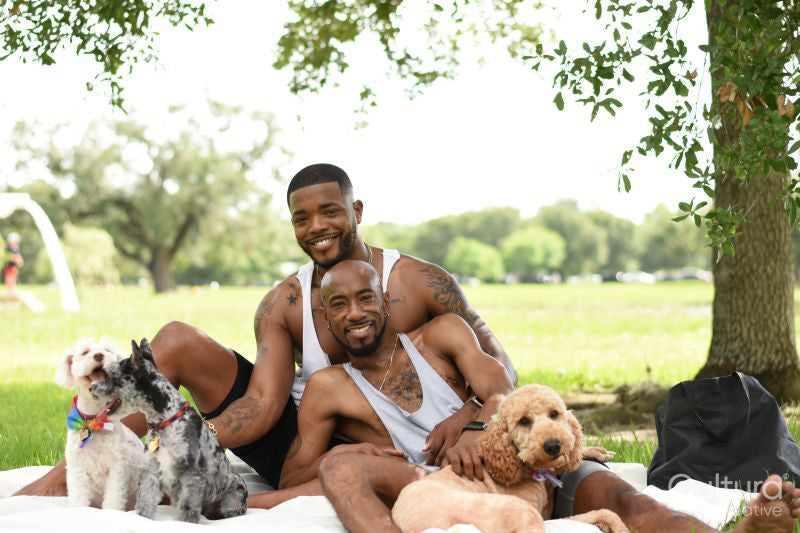Louisiana, Portrait of couple with dogs having picnic on lawn in park