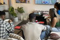 Friends watching American football on TV at home