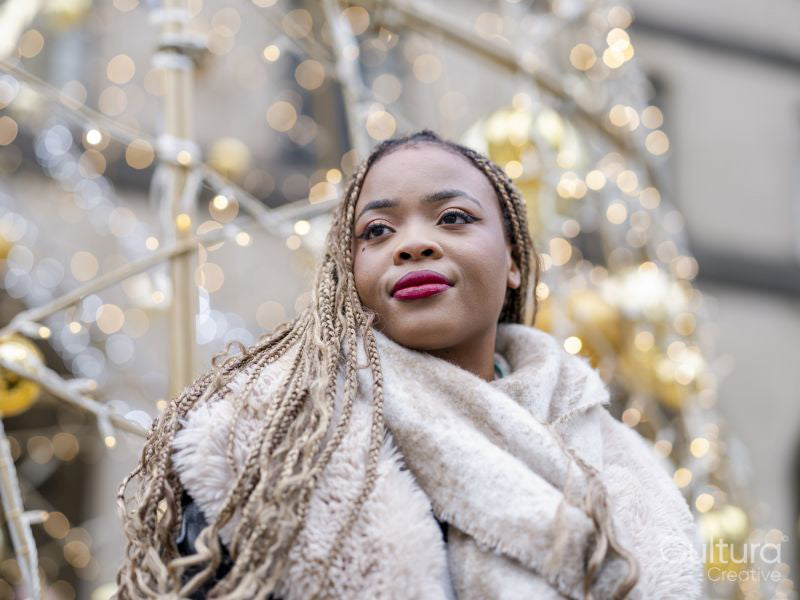 Young woman standing against Christmas decorations