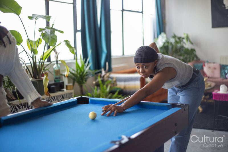 Women playing pool at home