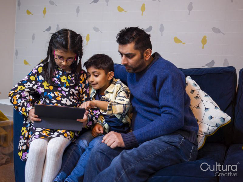 Father and children using digital tablet