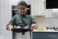 Woman opening pressure cooker pot in kitchen