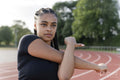Female athlete stretching arms before training