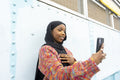 Smiling young woman wearing hijab taking selfie