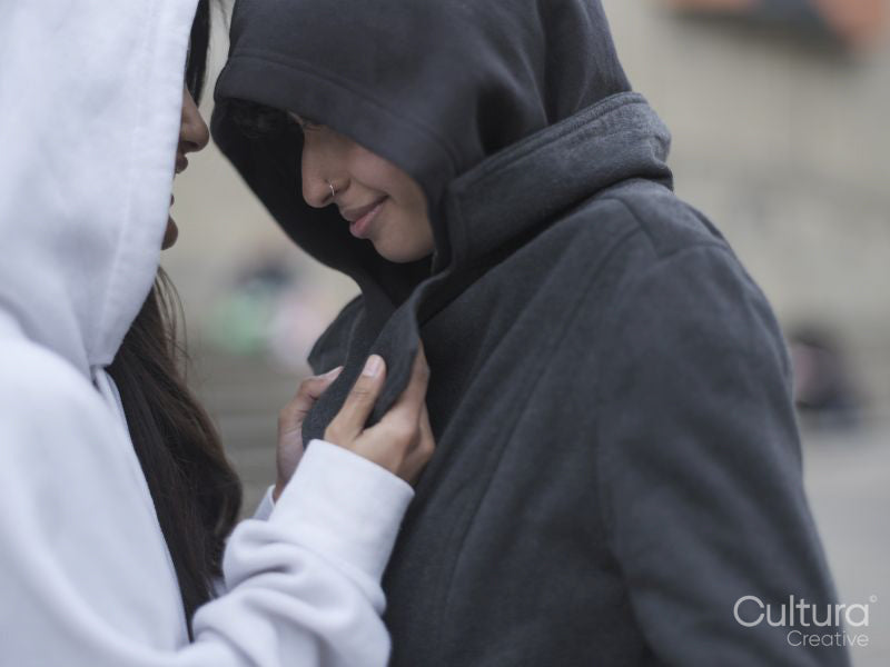 Smiling female couple in black and white hoodies