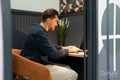 Smiling businessman working on laptop in office