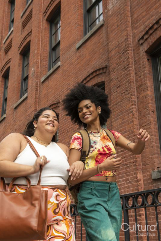 Two women in front of brick building