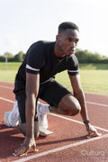 Athlete preparing to sprint at running track