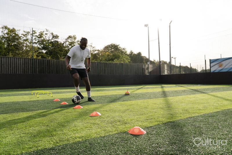 Soccer player practicing on soccer field