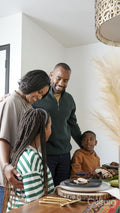 Family with children having Kwanzaa meal