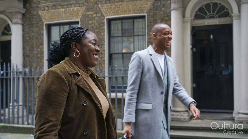 Business man and woman walking down street