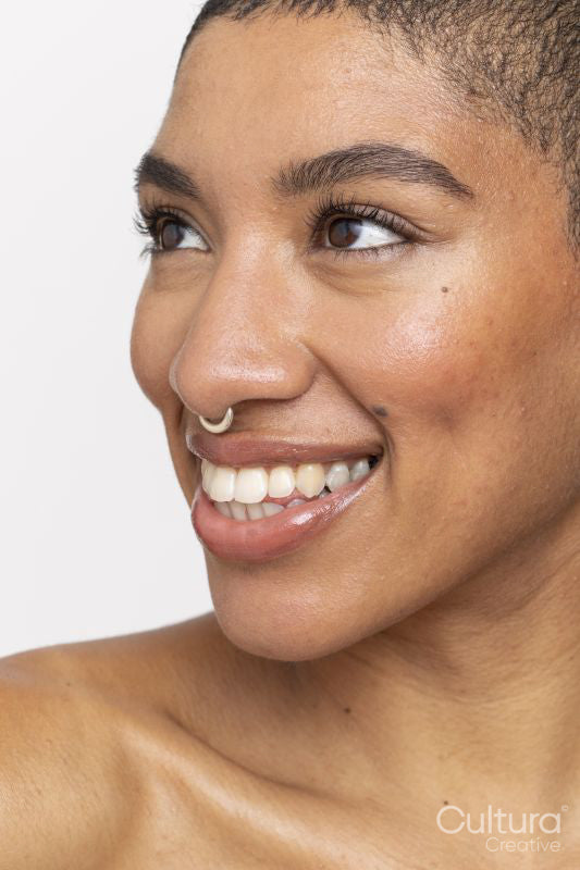 Close-up of smiling woman with nose ring