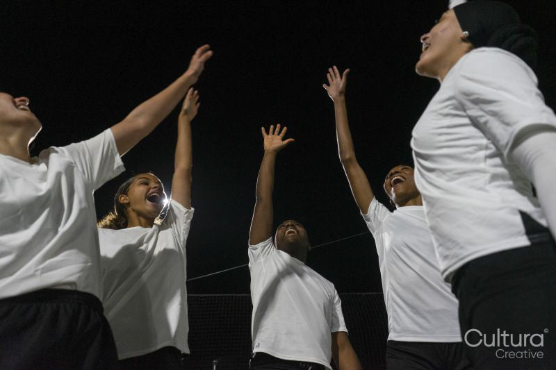 Female soccer players teaming up