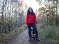 Woman hiking in forest with dogs