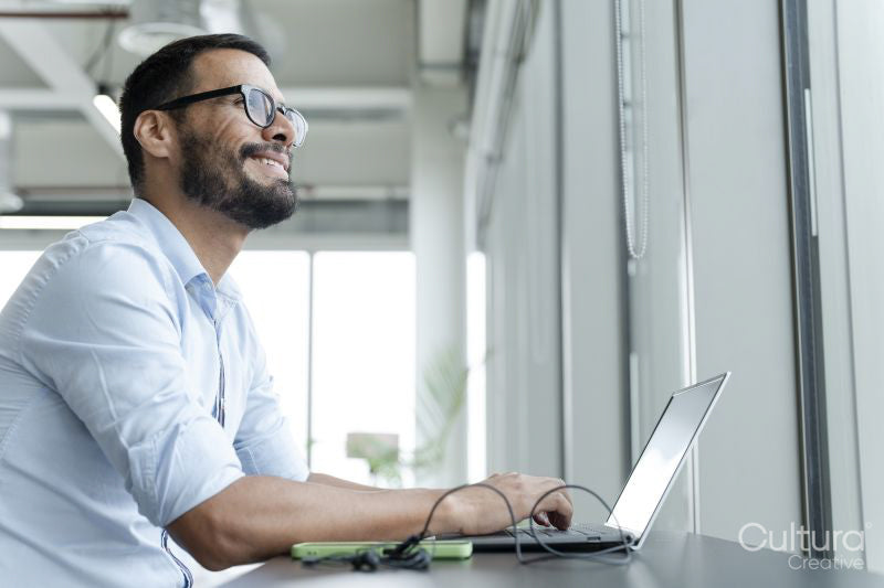 Businessman with laptop working in modern office