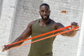 Mid adult man exercising with resistance band