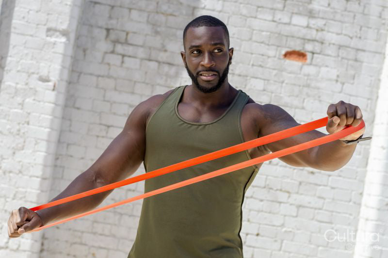 Mid adult man exercising with resistance band