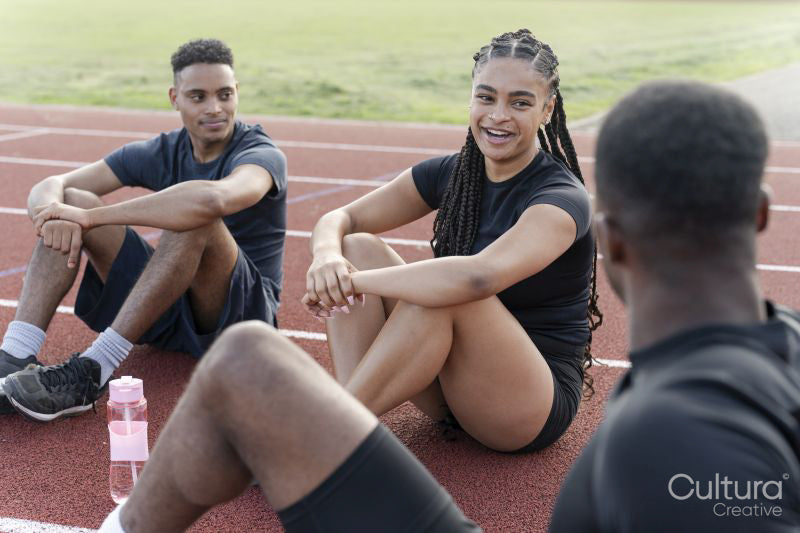 Group of athletes resting at sports track after training