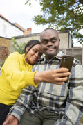 Mother and adult son with Down syndrome taking selfie