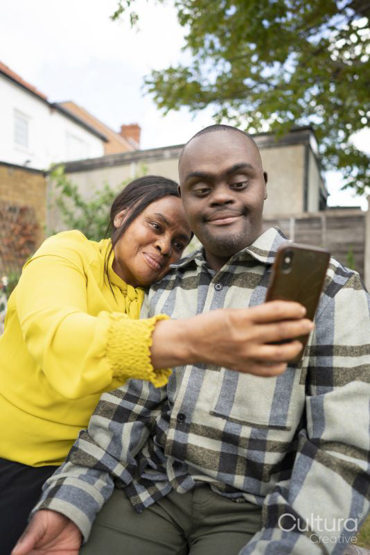 Mother and adult son with Down syndrome taking selfie