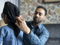 Father wrapping turban around sons head