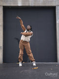 Young woman in sports clothing dancing in city