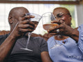 Couple holding wineglasses raising a toast