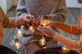 Friends untangling string light, close up