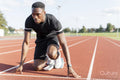 Athlete preparing to sprint at running track