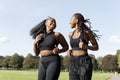 Young female friends jogging in park