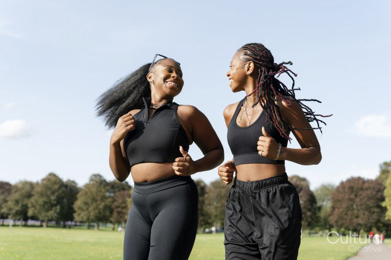 Young female friends jogging in park