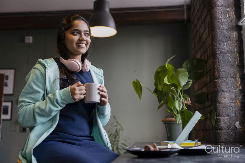 Female student drinking tea while studying