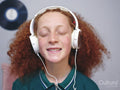 Girl listening to music on headphones