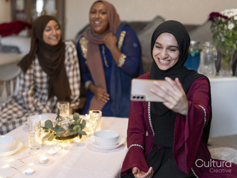 Smiling women taking selfie during Ramadan at home