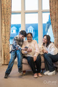 Boy showing grandmother smart phone in nursing home