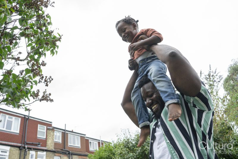 Father giving daughter piggyback ride