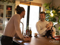 couple feeding baby daughter in kitchen