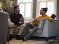 couple drinking red wine on sofa